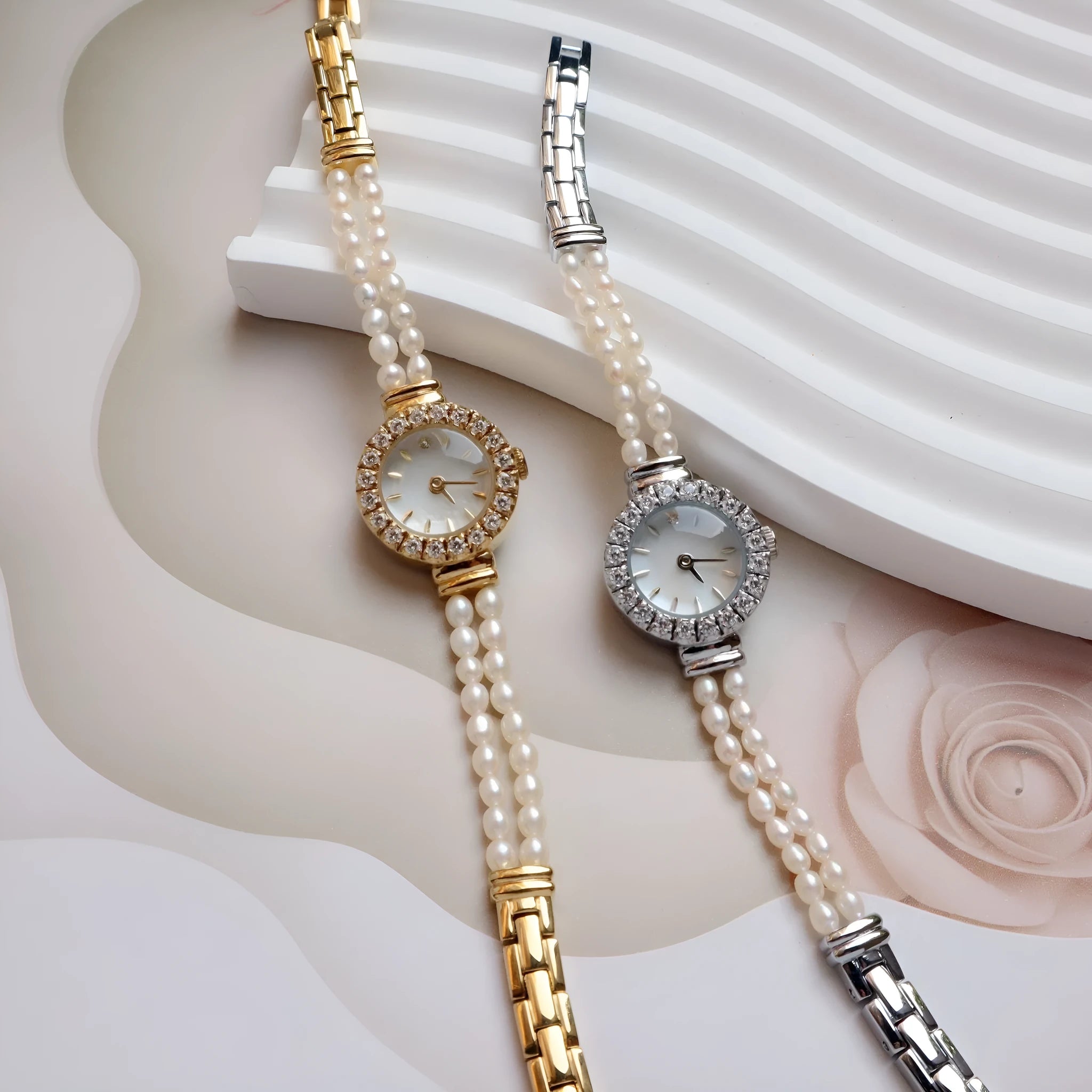 Women's light gold bracelet watch with freshwater pearls on a round 18mm dial.