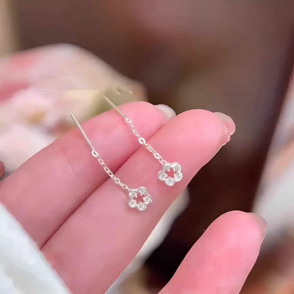 Silver hollow flower drop earrings with natural petal design and butterfly closure