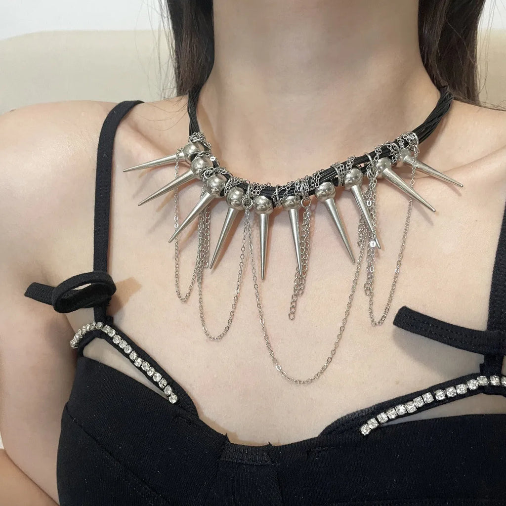 Women's leather necklace with winding beads, a tassel, and metallic point rivets.