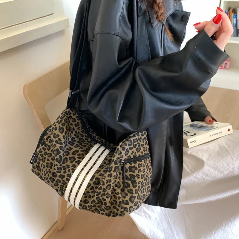 Leopard print crossbody messenger bag with stitching details and shoulder strap