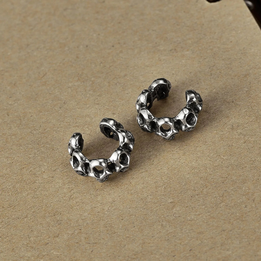 Retro hollow skull ear clip earrings with stainless steel construction and geometric hip hop style design