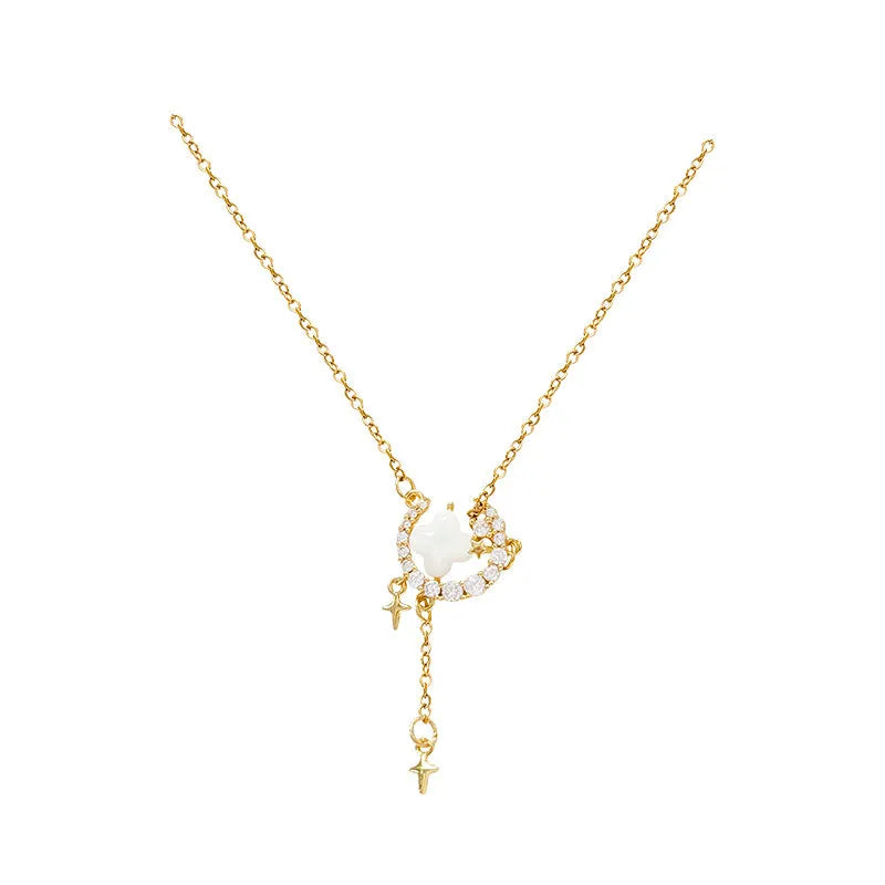 Gold-tone star and moon pendant necklace on an adjustable copper chain.