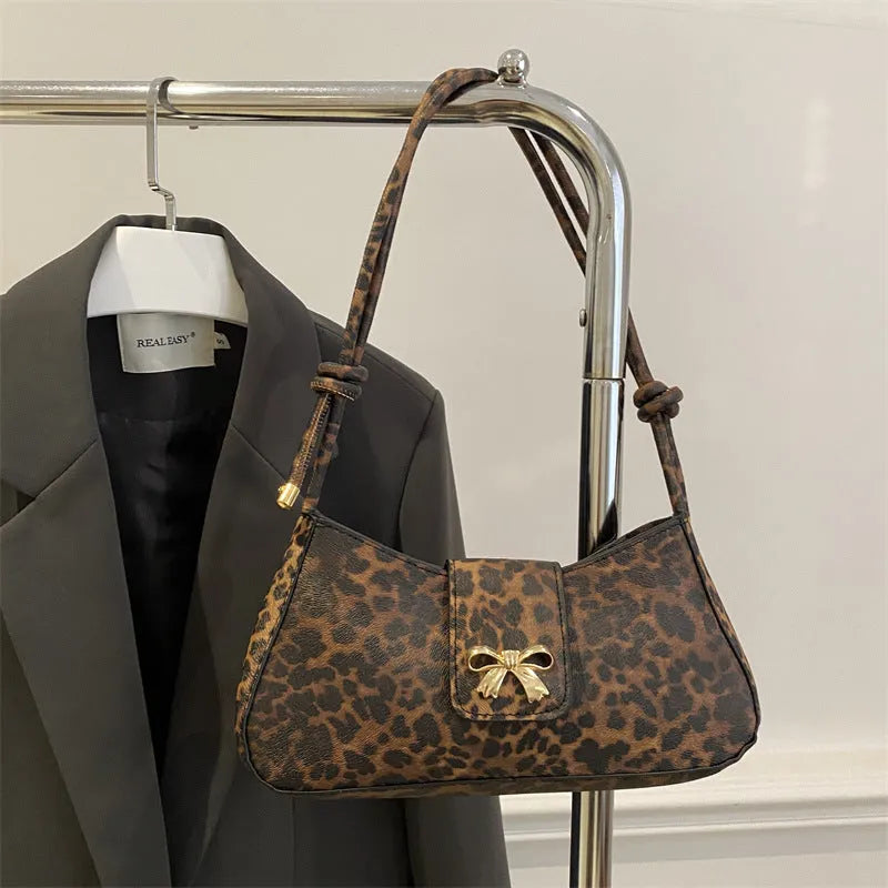 Casual large capacity PU handbag for women in black, shown with outer sandwich pocket.