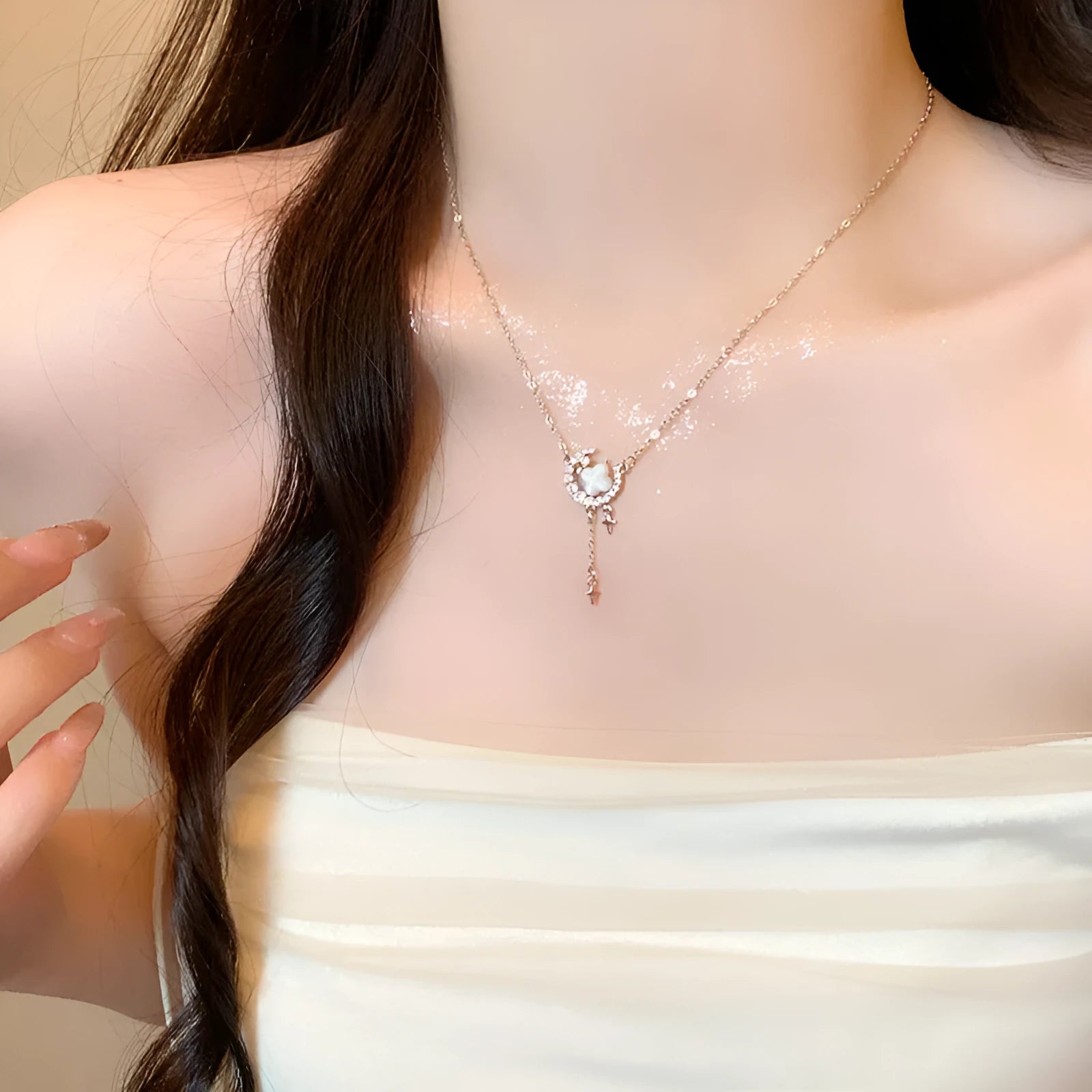 Gold-tone star and moon pendant necklace on an adjustable copper chain.