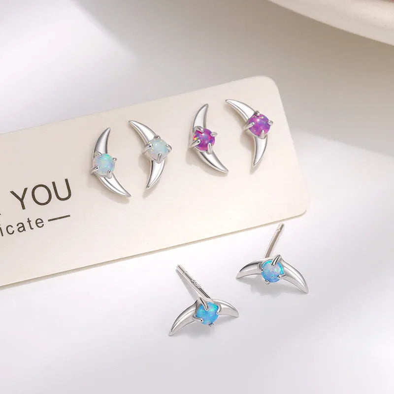 A pair of geometric 925 silver earrings with a stone accent, shown in gold and platinum colour options.