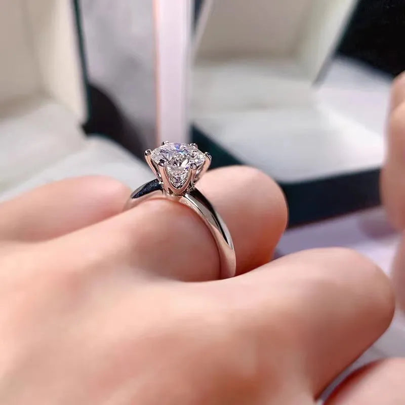 White gold plated geometric ring with six-claw setting holding a zircon stone.