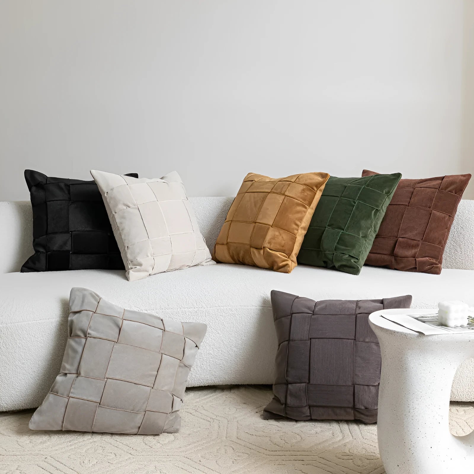 Square chenille woven sofa cushion in taupe colour on a grey sofa, showing textured fabric detail
