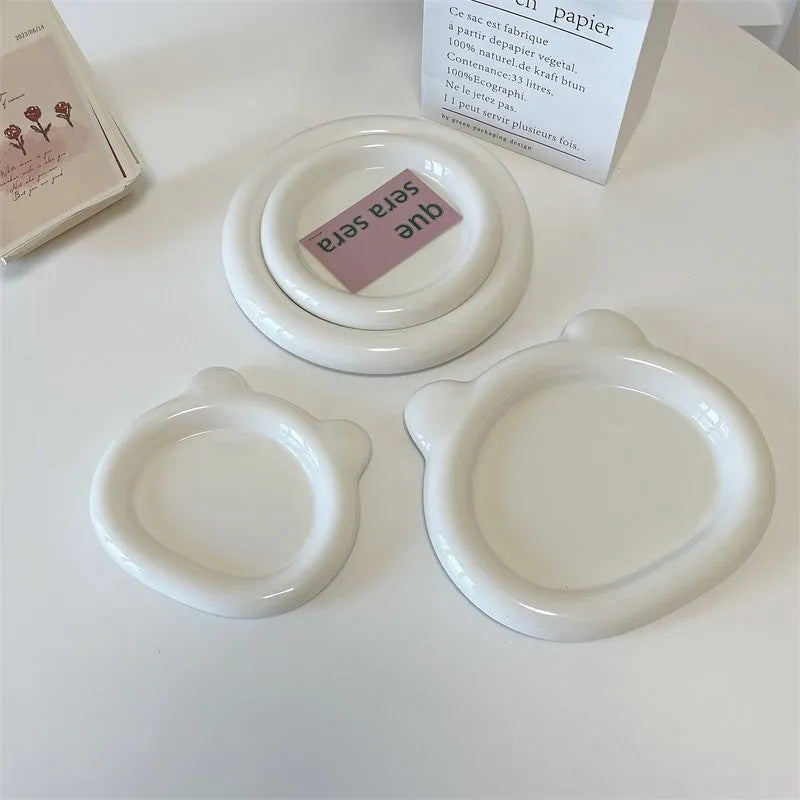 White porcelain plate with cute bear doodle design, 20cm size, on a table.