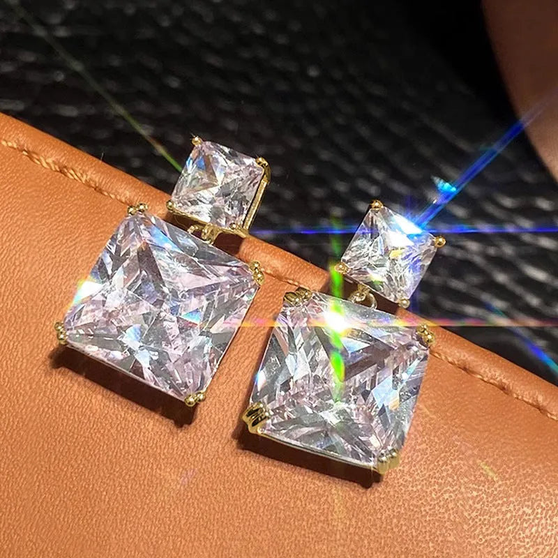 A pair of geometric square design copper earrings in a choice of white gold or gold colour.