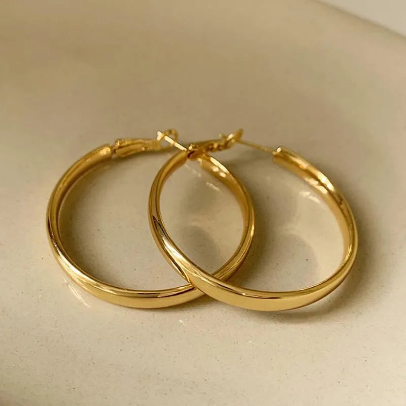 Circular copper hoop earrings with 40mm diameter in gold or silver electroplated finish