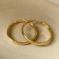 Circular copper hoop earrings with 40mm diameter in gold or silver electroplated finish