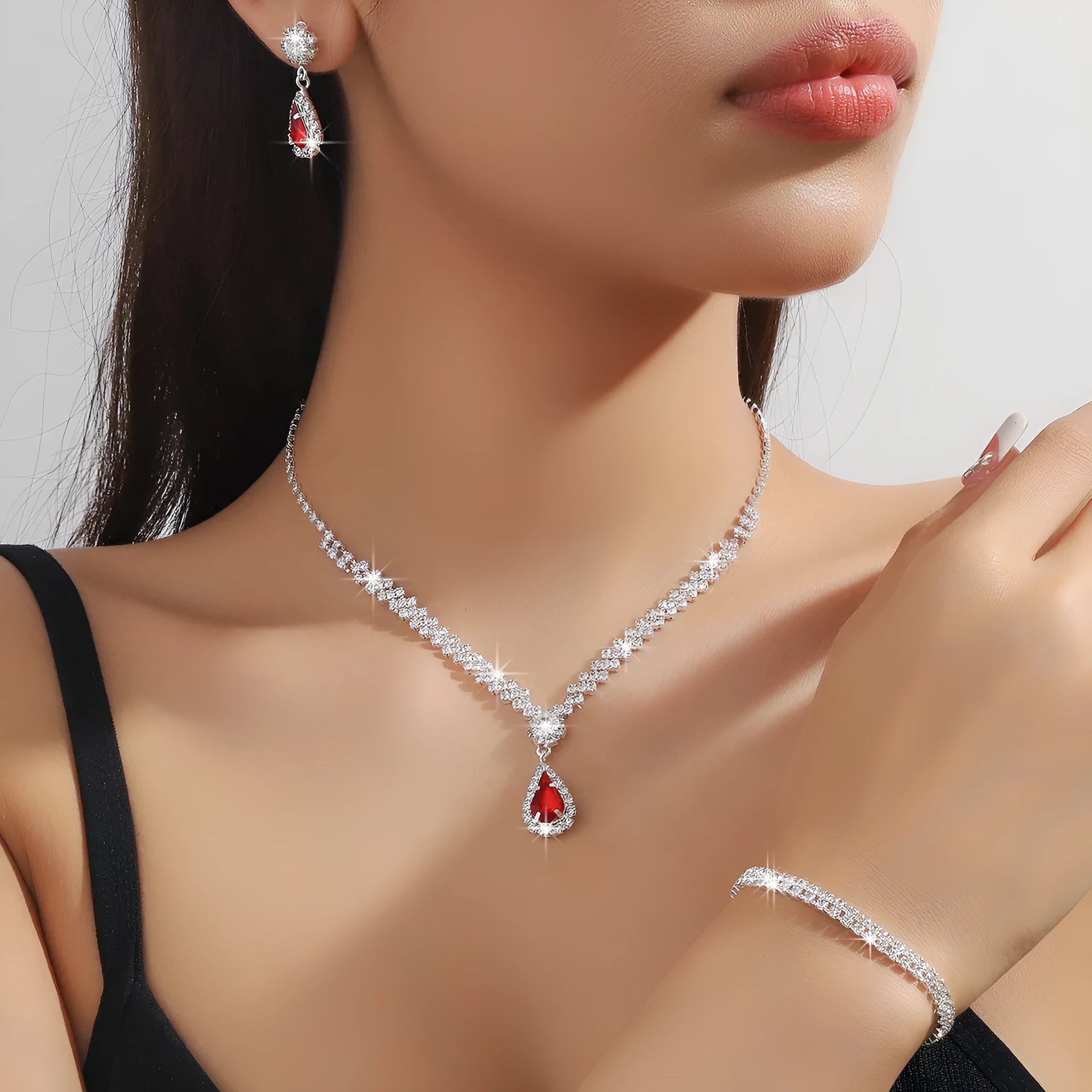 Claw chain necklace and earrings set with drop-shaped rhinestones in multiple colour options