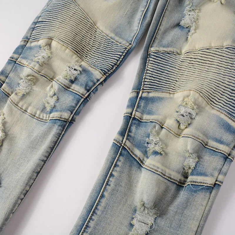 Men's light blue distressed slim fit jeans with hand-frayed details and straight leg opening