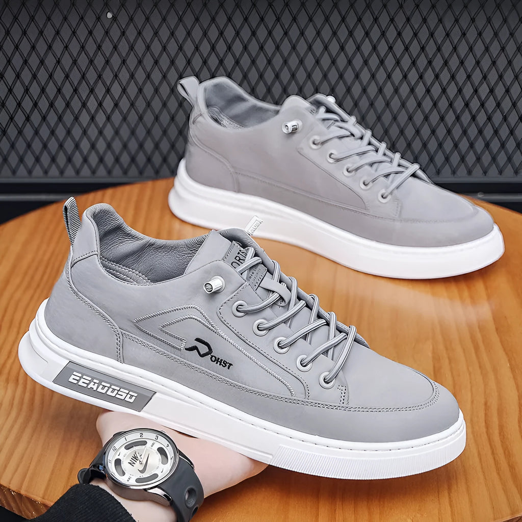 Grey men's canvas lace-up sneakers with stitching detail and a low-top round toe design.