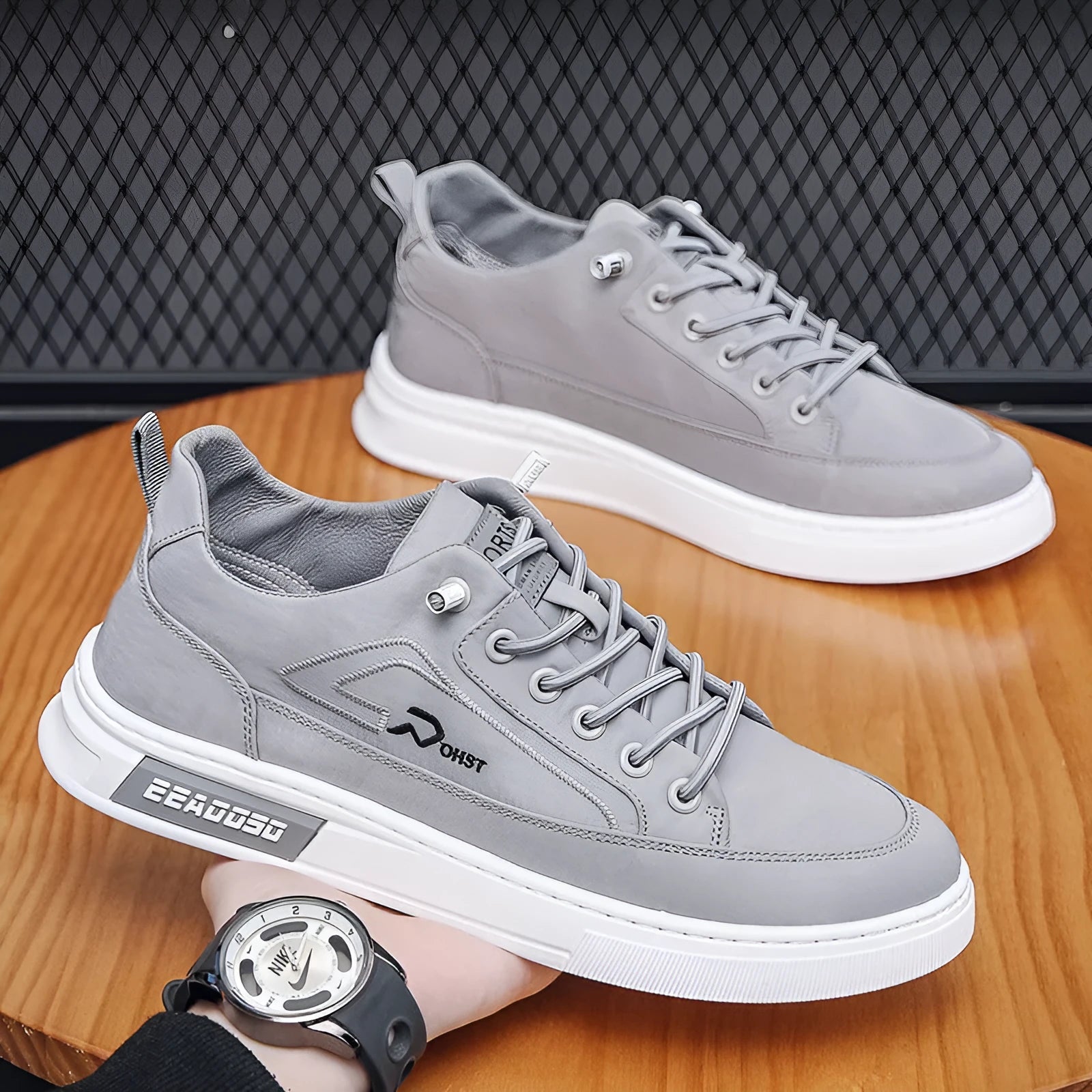 Grey men's canvas lace-up sneakers with stitching detail and a low-top round toe design.