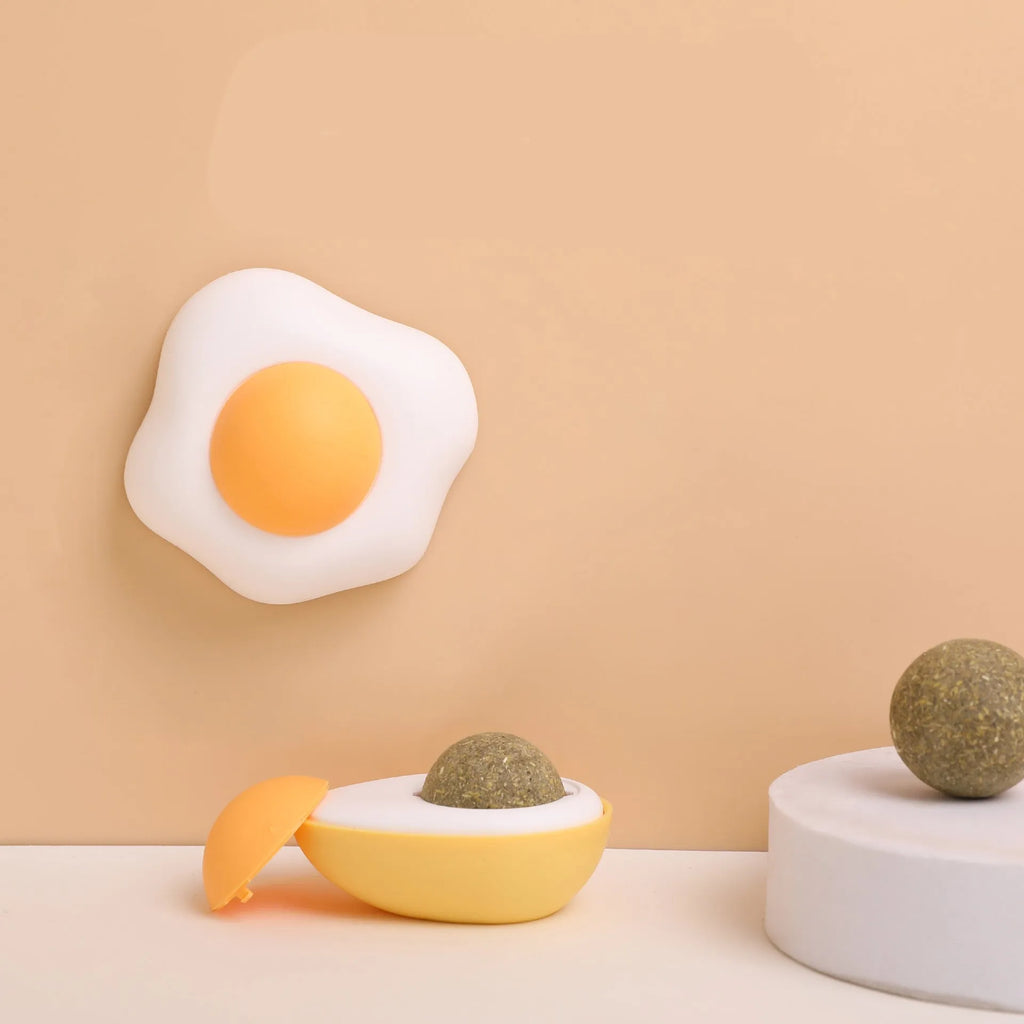 Interactive catnip ball toy with 360 rotation mounted on wall for feline teeth cleaning play