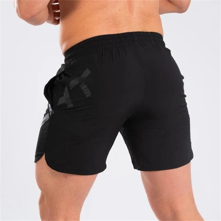 Men's black knee-length quick-dry nylon running shorts laid flat, showing mid-waist and sport design.