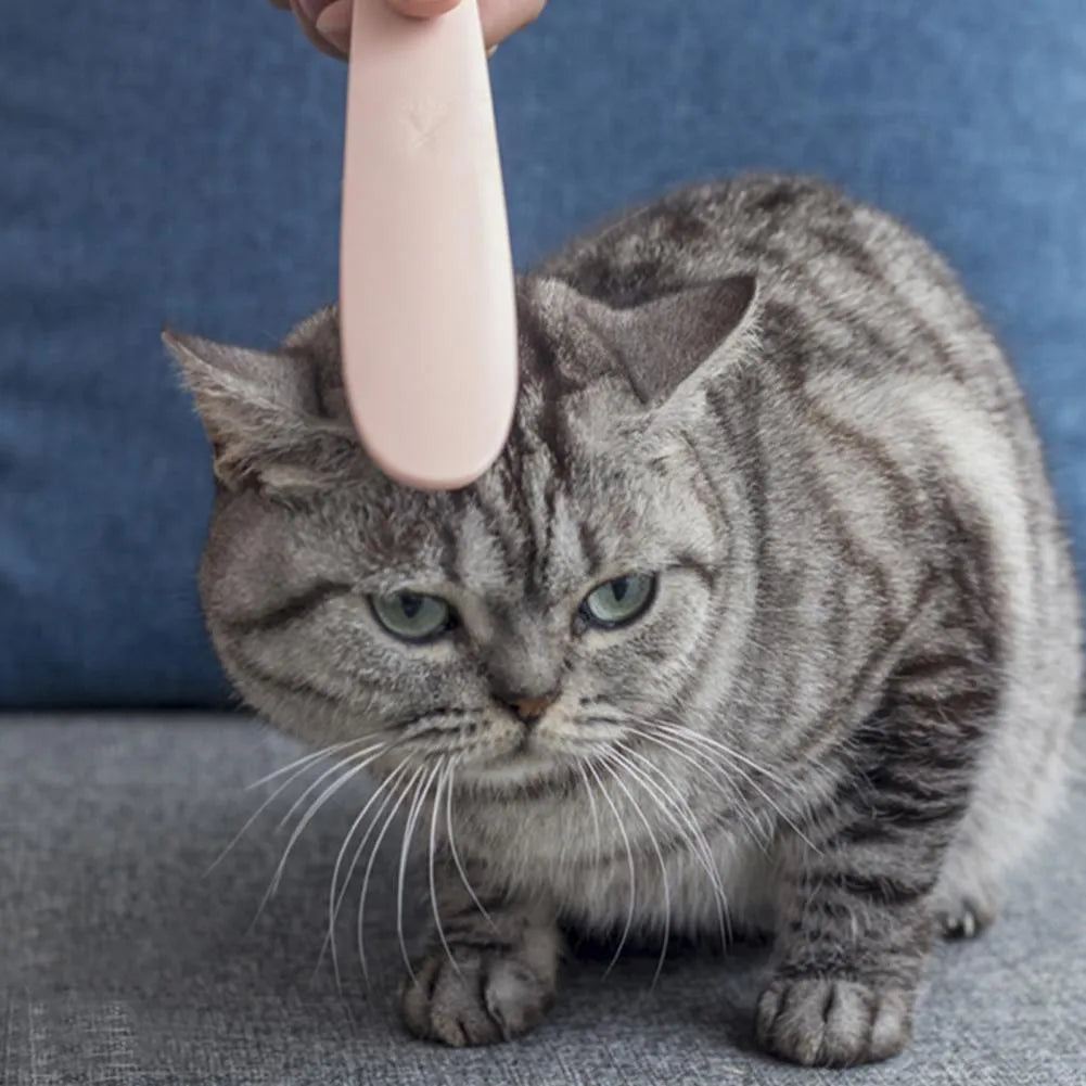 Grey cat grooming comb with tongue massager design showing narrow and wide ends