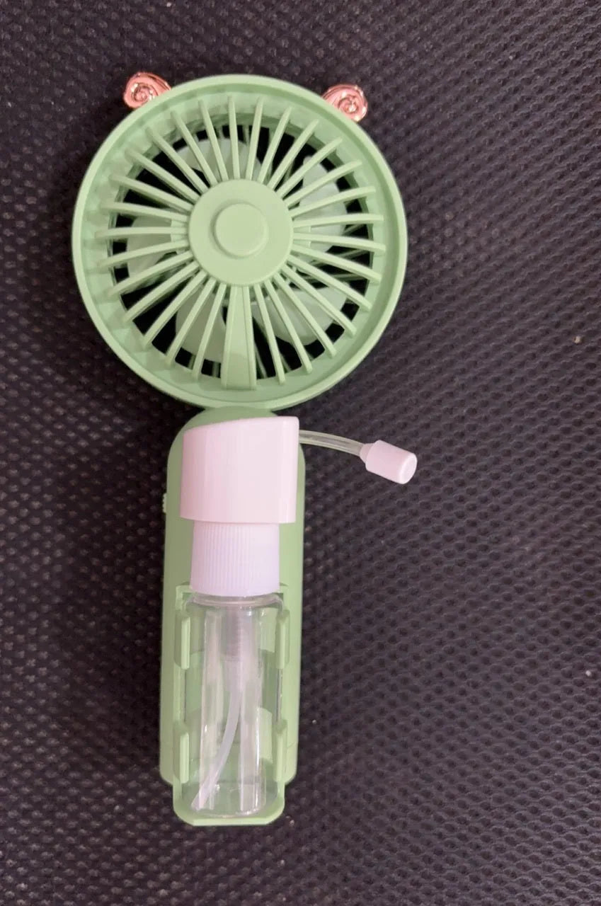 Compact plastic USB desk fan in apricot colour with personalised nozzle, showing scale next to a pen.