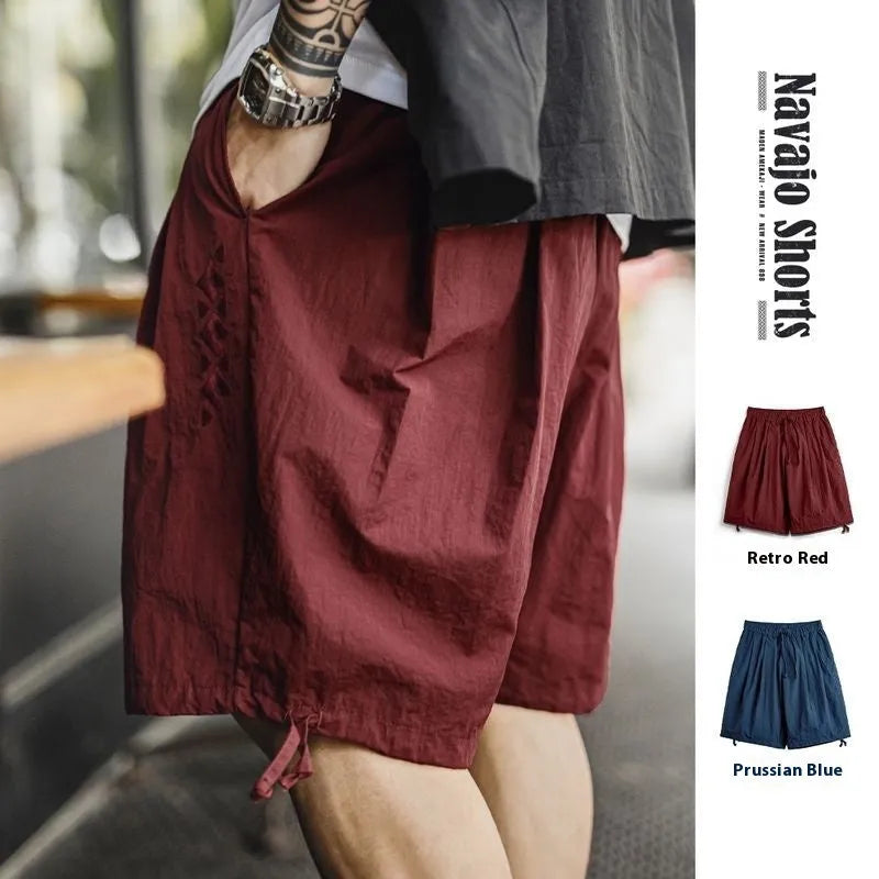 Men's loose-fit Prussian Blue nylon beach shorts with embroidered design on thigh