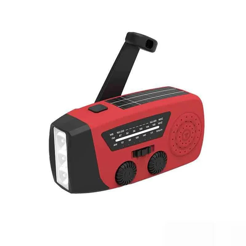 Red rechargeable emergency hand crank radio torch with USB port and wrist strap