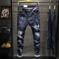Men's slim-fit skinny jeans in dark blue denim laid flat, showing front design and button fly.