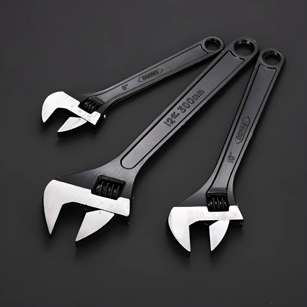 High carbon steel adjustable open-end spanner with black finish on a workbench.