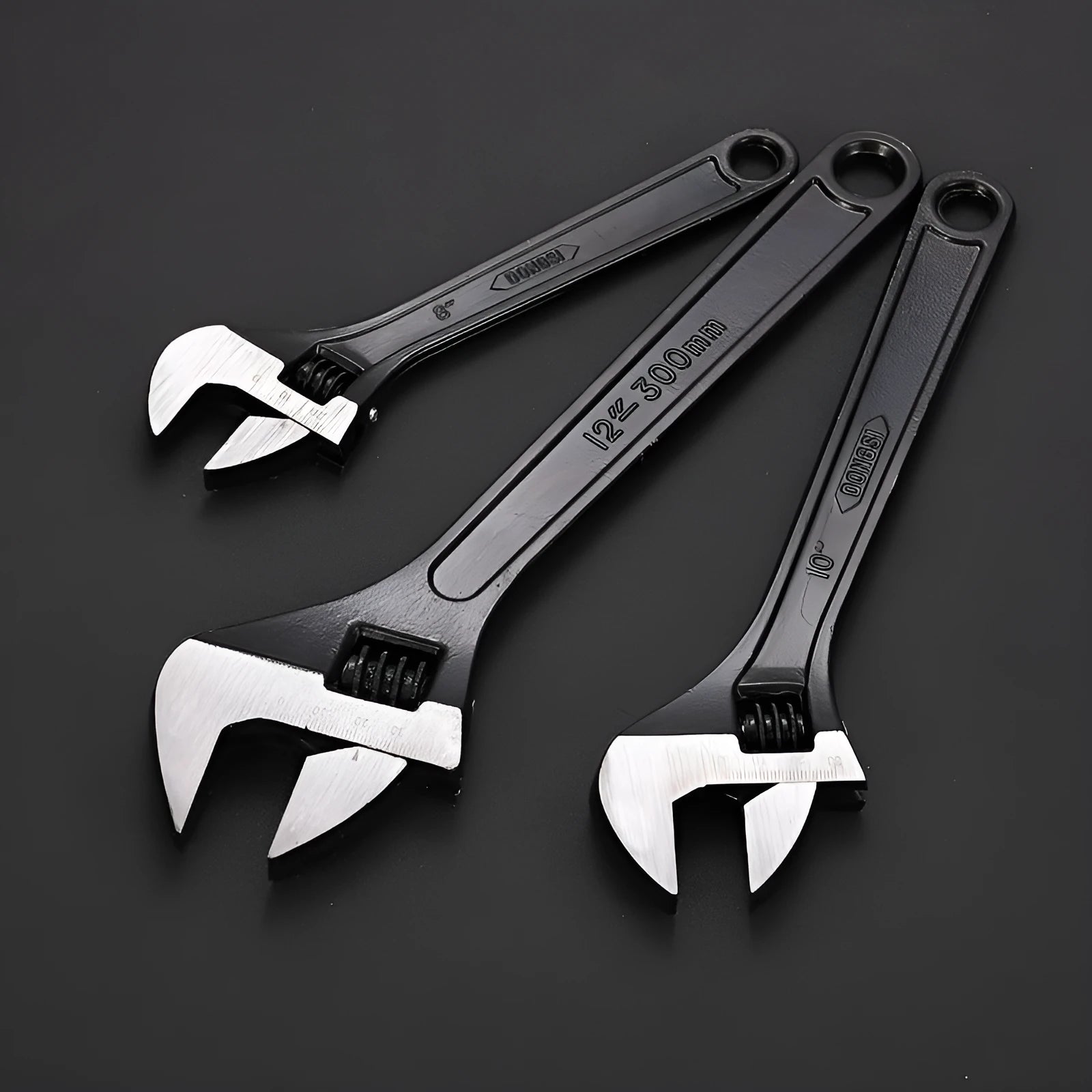 High carbon steel adjustable open-end spanner with black finish on a workbench.
