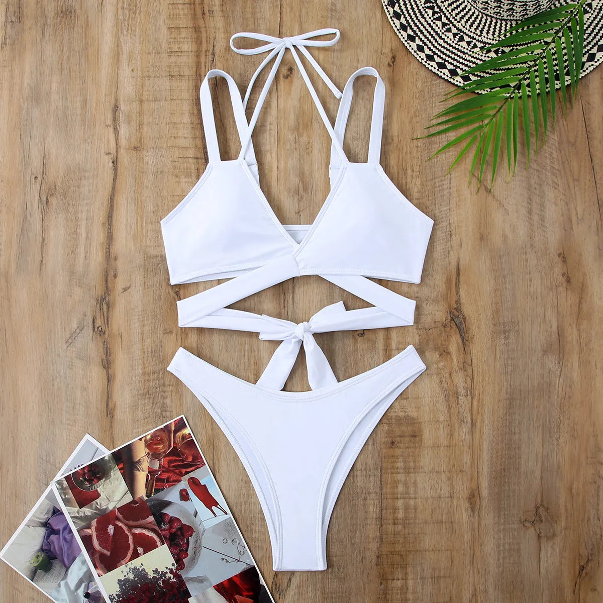 Solid colour women's strap bikini swimsuit on a hanger, shown in one of five colour options.