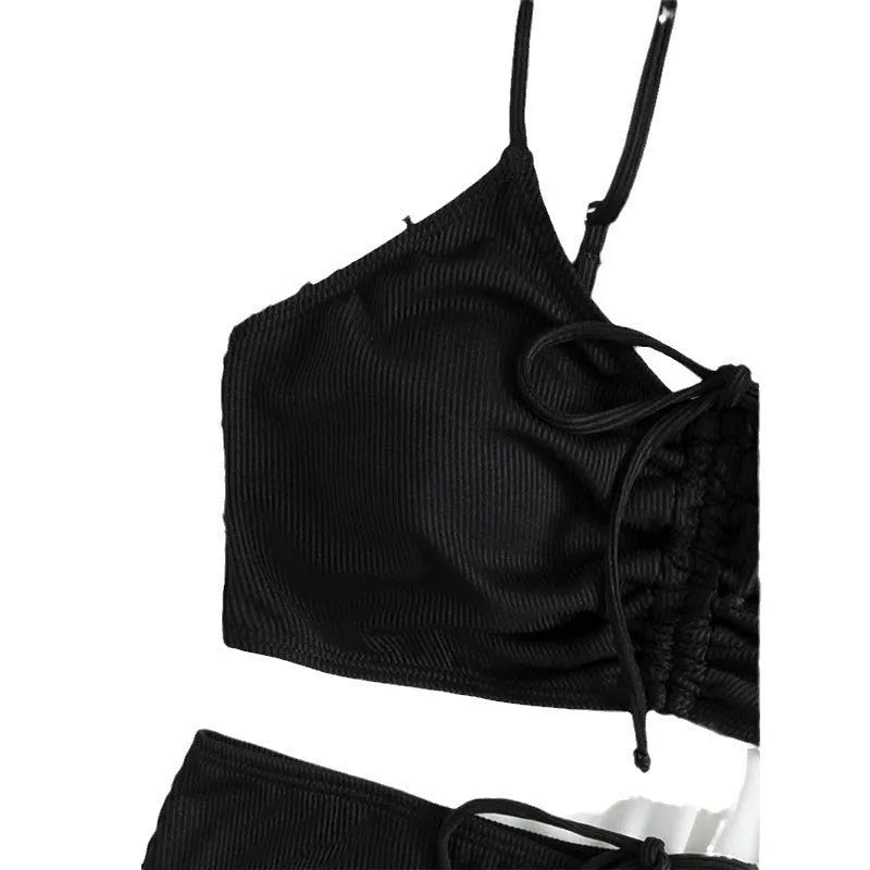 Black women's swimsuit set with sling bikini top and high-waist shorts with side splits