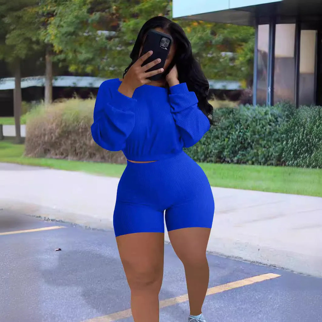 Women's solid colour off-the-shoulder long sleeve top and shorts two-piece set with sunken stripe pattern.