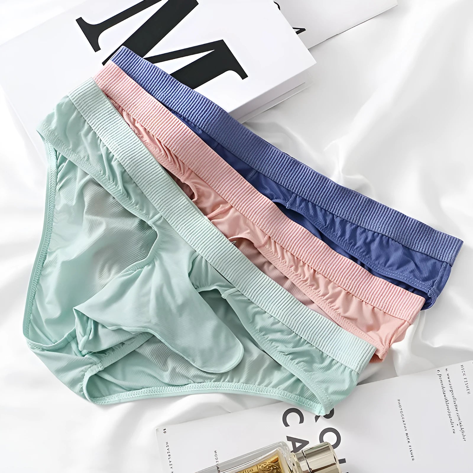 Men's low waist ice silk briefs in black, shown flat to display the classic briefs cut and elasticated waistband.