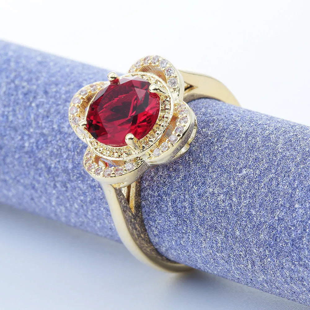 Copper ring with fruit-shaped setting holding a faceted zircon stone.