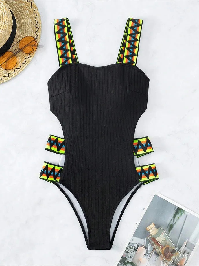 Women's black and orange solid colour one-piece polyester swimsuit on hanger