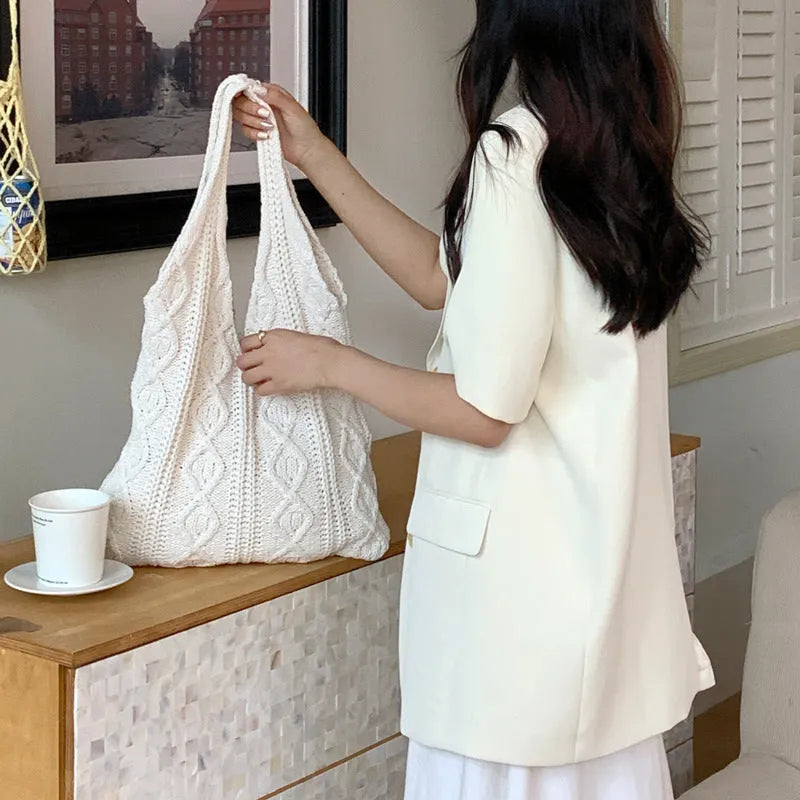Retro hollow-knitted shoulder tote bag in solid colour with double straps showing textured yarn construction