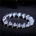 Women's original design white crystal pyramid bracelet with Ruyi charm on wrist.