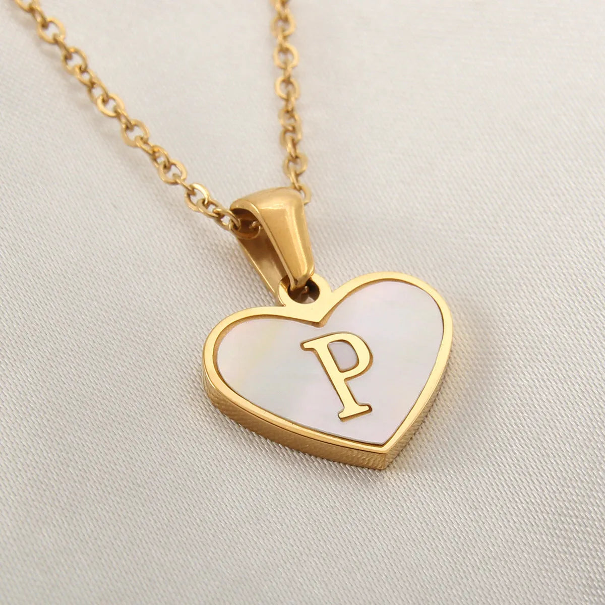Gold plated heart necklace with white shell detail on an adjustable chain