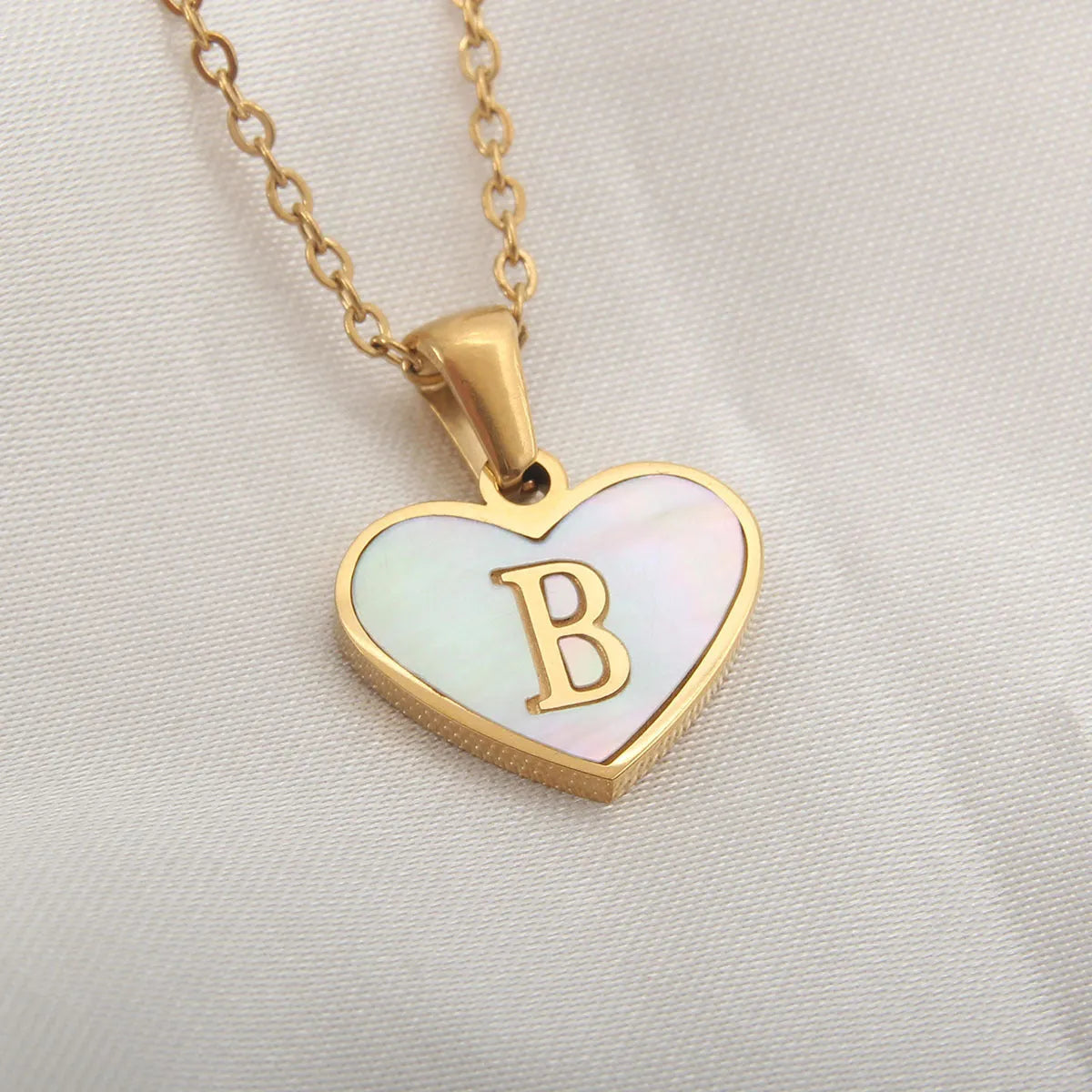 Gold plated heart necklace with white shell detail on an adjustable chain