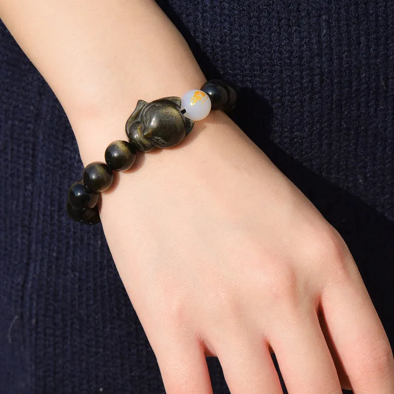 10mm obsidian zodiac bracelet on wrist showing adjustable cord closure and polished stone beads