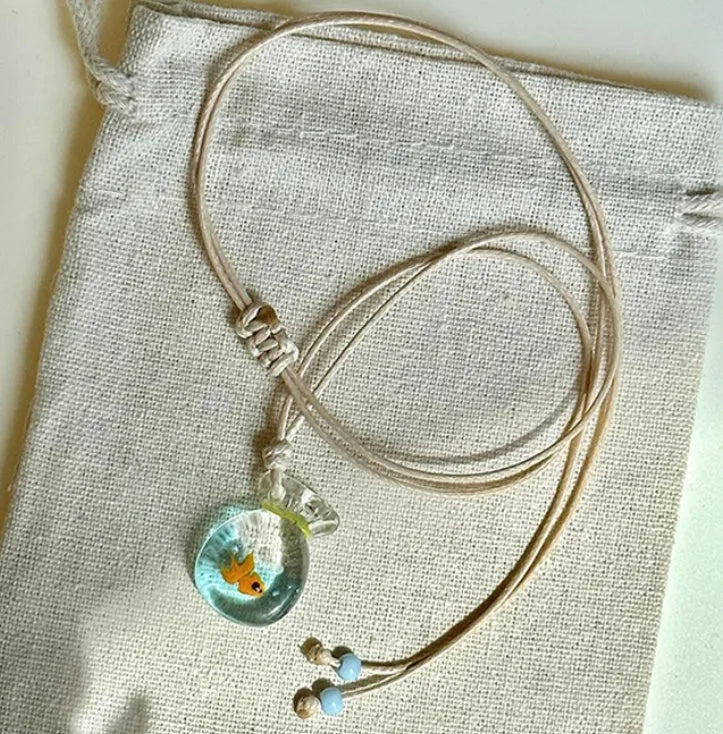 Women's pendant necklace with coloured glaze skirt joker character on a cotton linen clavicle chain.