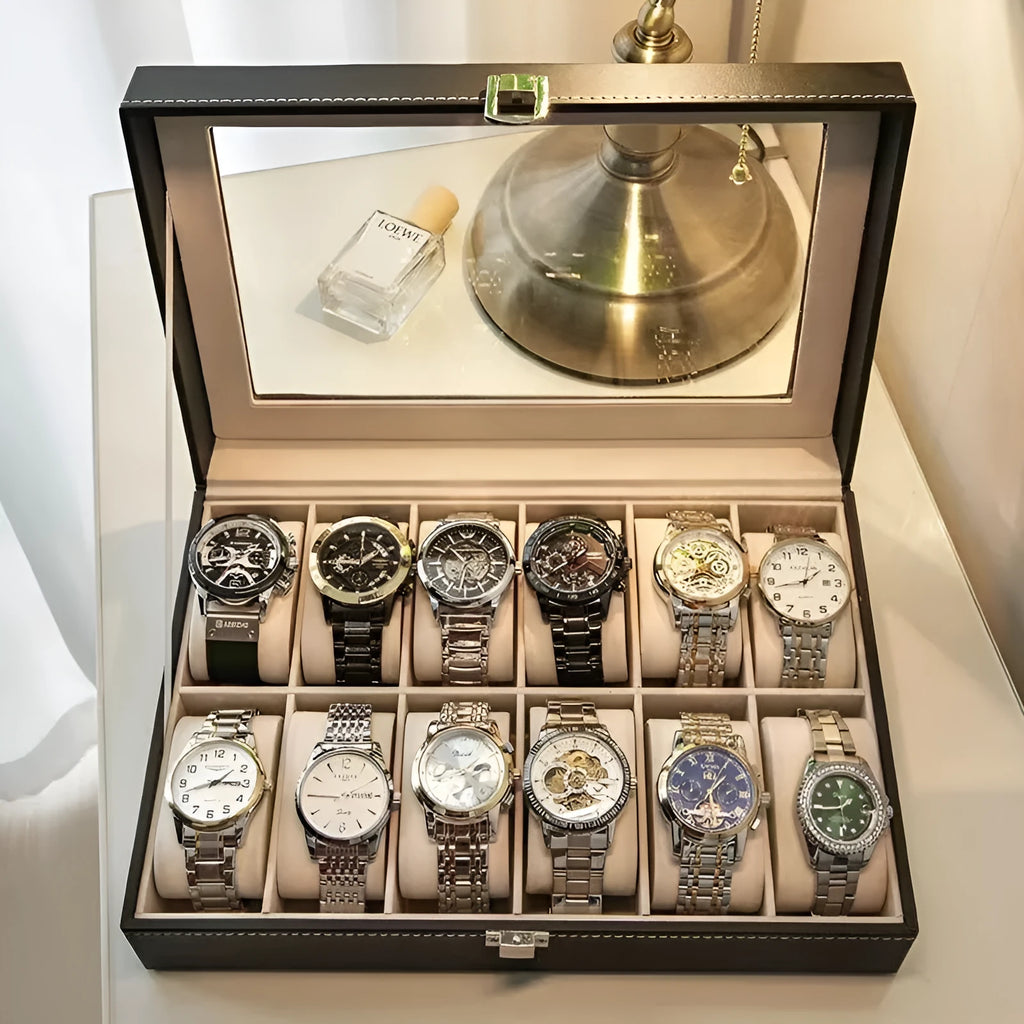 Grey leather watch storage box with clear dustproof lid showing multiple watch compartments inside.