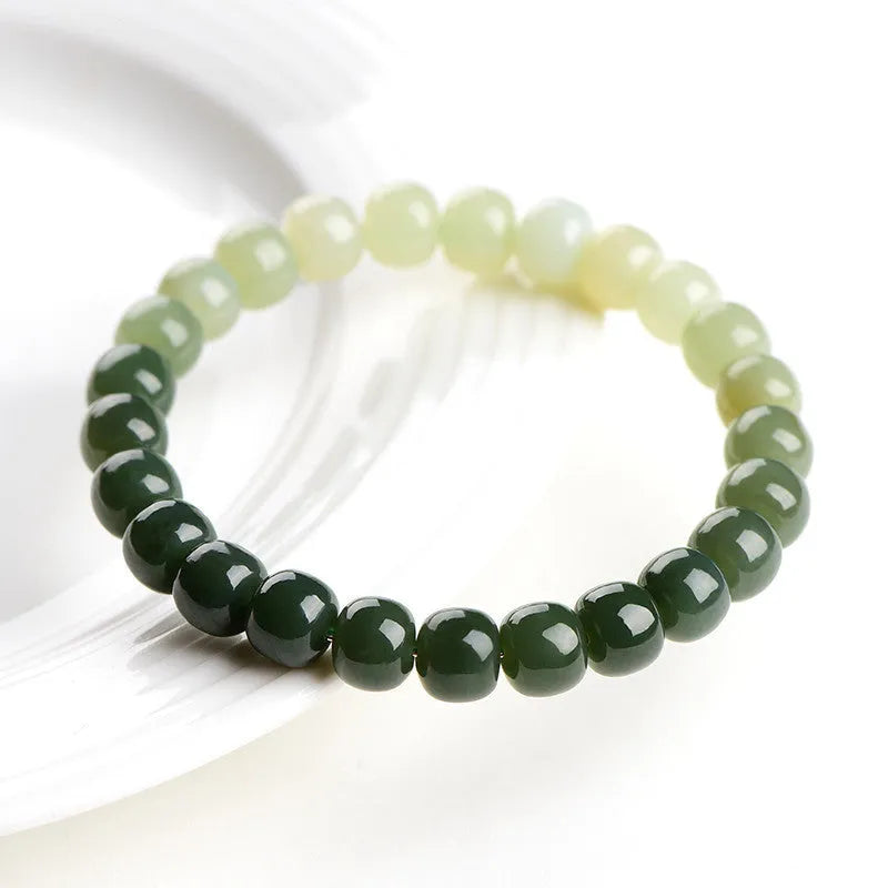 Natural Hetian jade bracelet with water gradient colour on a wrist.
