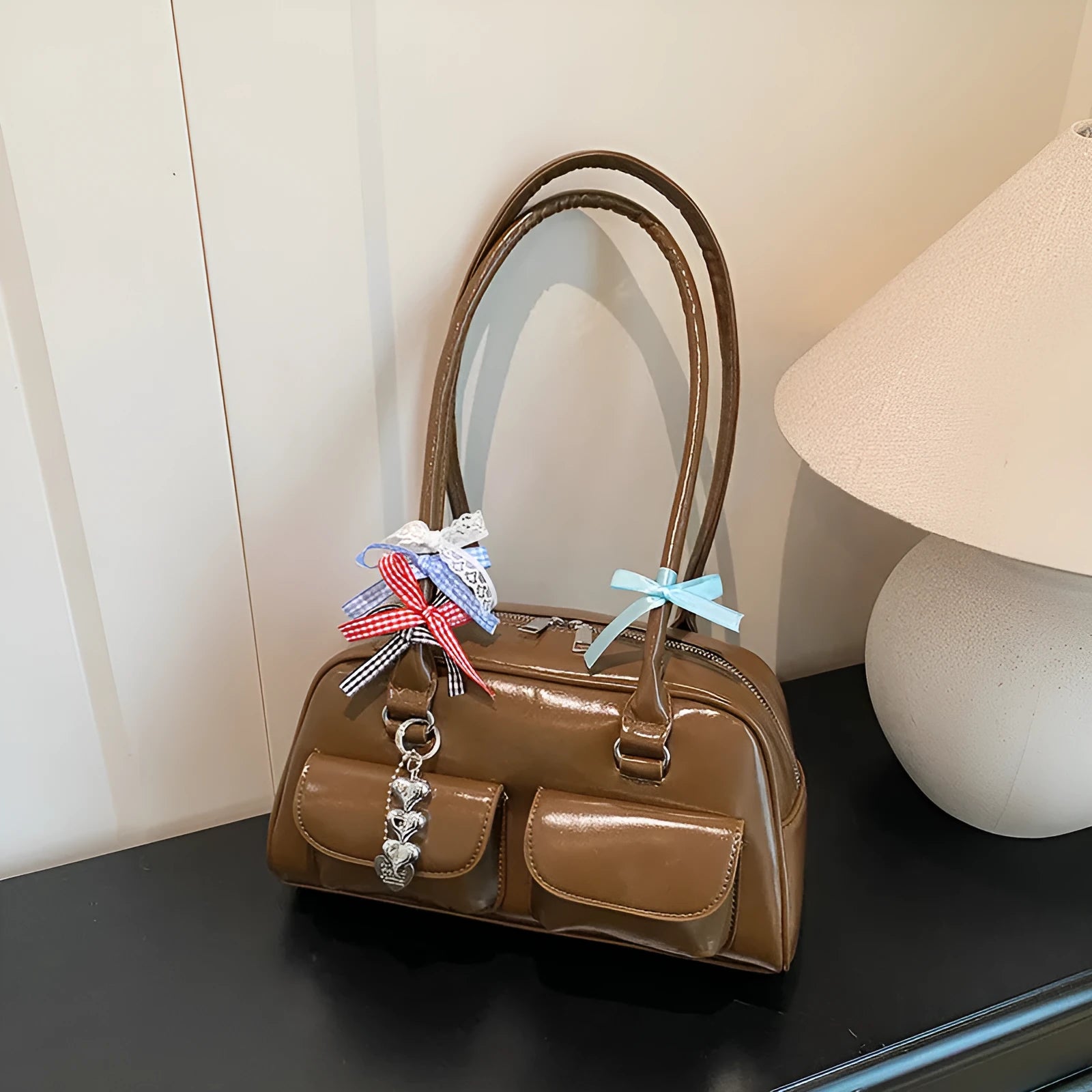 Retro-style black PU leather women's pillow bag with double shoulder straps and a flap closure.