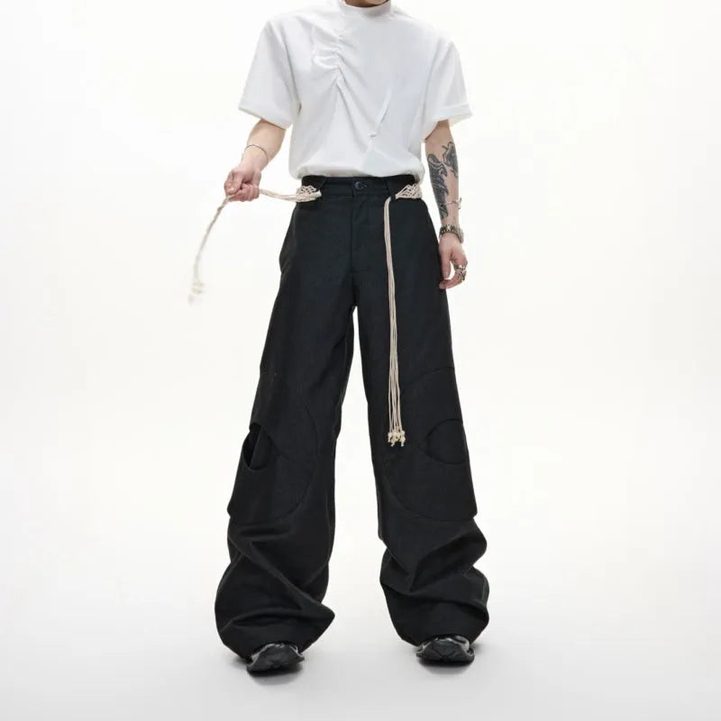 Men's dark blue straight-leg trousers with 3D cutting, zipper decorations, and a tassel pocket detail on a micro-elastic cotton fabric.