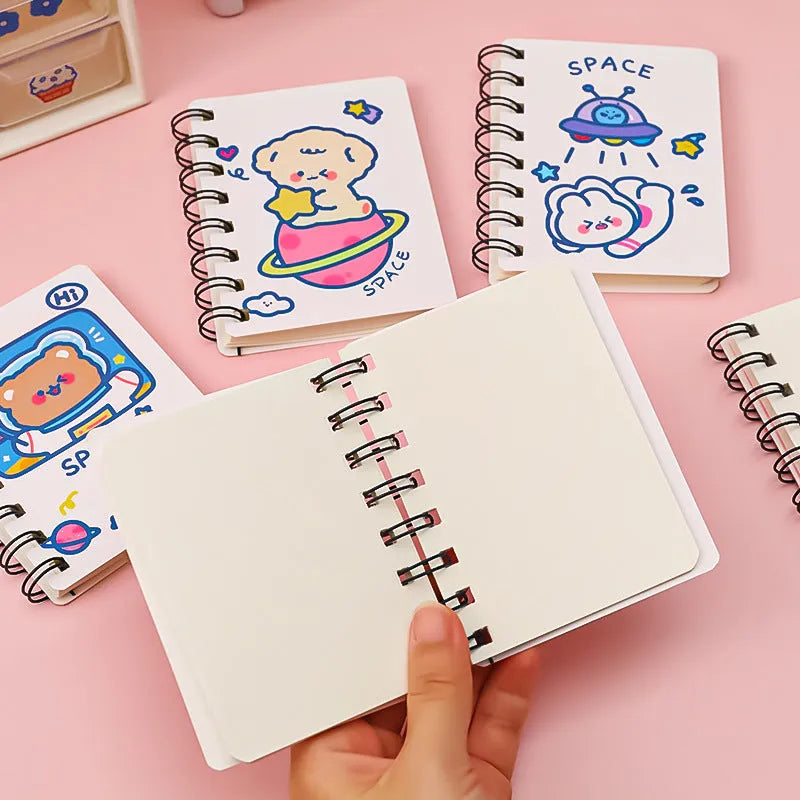 Astronaut themed pocket notebook showing 10.5 x 8 cm dimensions with space decoration