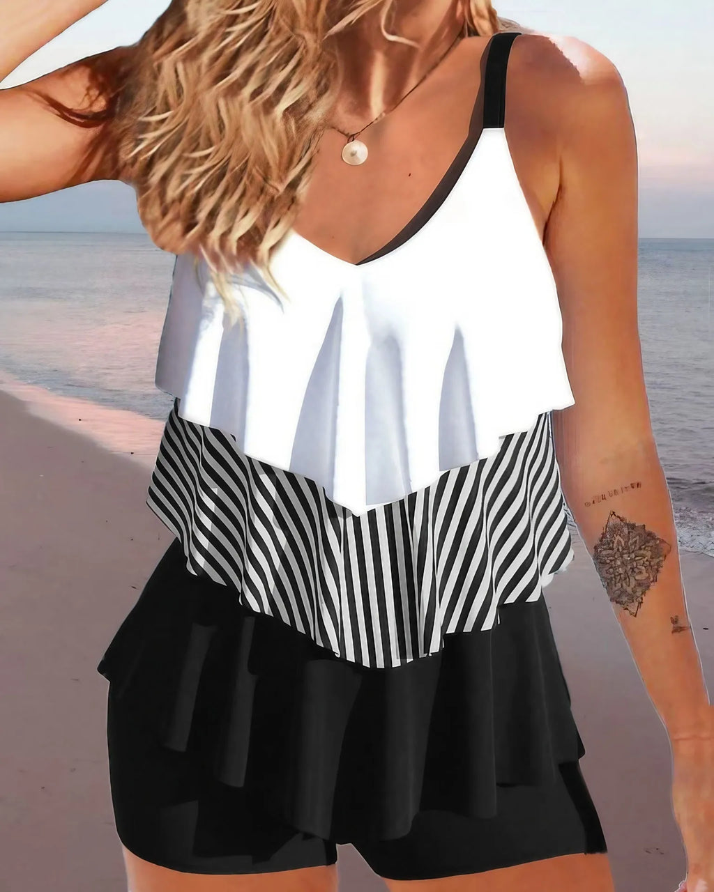 Women's sleeveless backless bikini with ruffles and spaghetti straps, shown in a floral print.