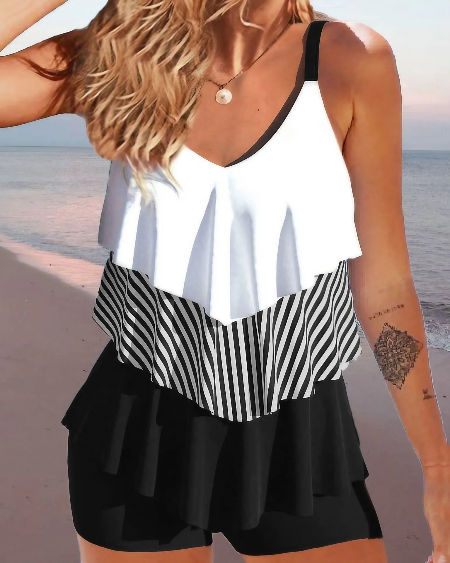 Women's sleeveless backless bikini with ruffles and spaghetti straps, shown in a floral print.