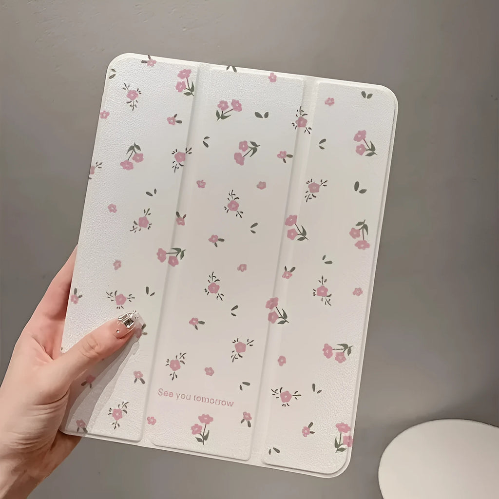 Transparent floral patterned tri-fold protective case for Apple iPad in stand position.