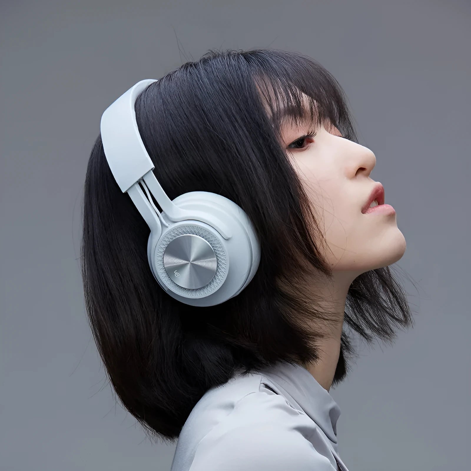Wireless Bluetooth sports headset in black, green, grey, or red colours showing ear cup.