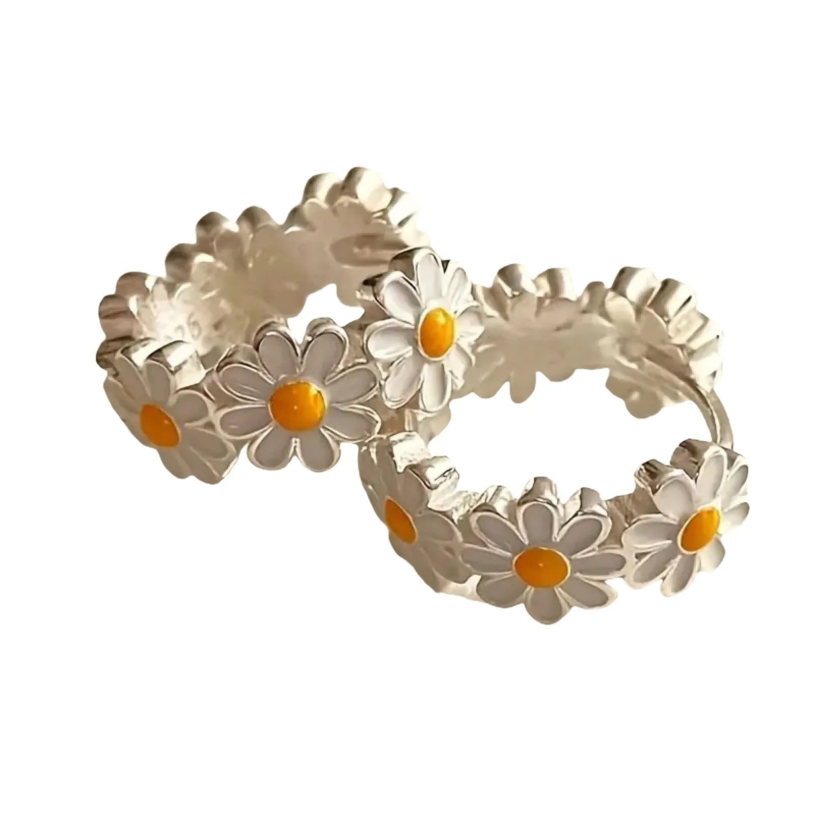 Close-up of white daisy flower ring earrings with gemstone centre on copper setting.